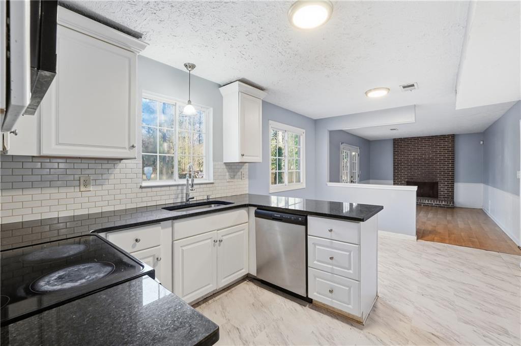 4828 Oak Path Stone Mountain, GA 30088 - Photo 9 of 40 a kitchen with a sink stove and cabinets