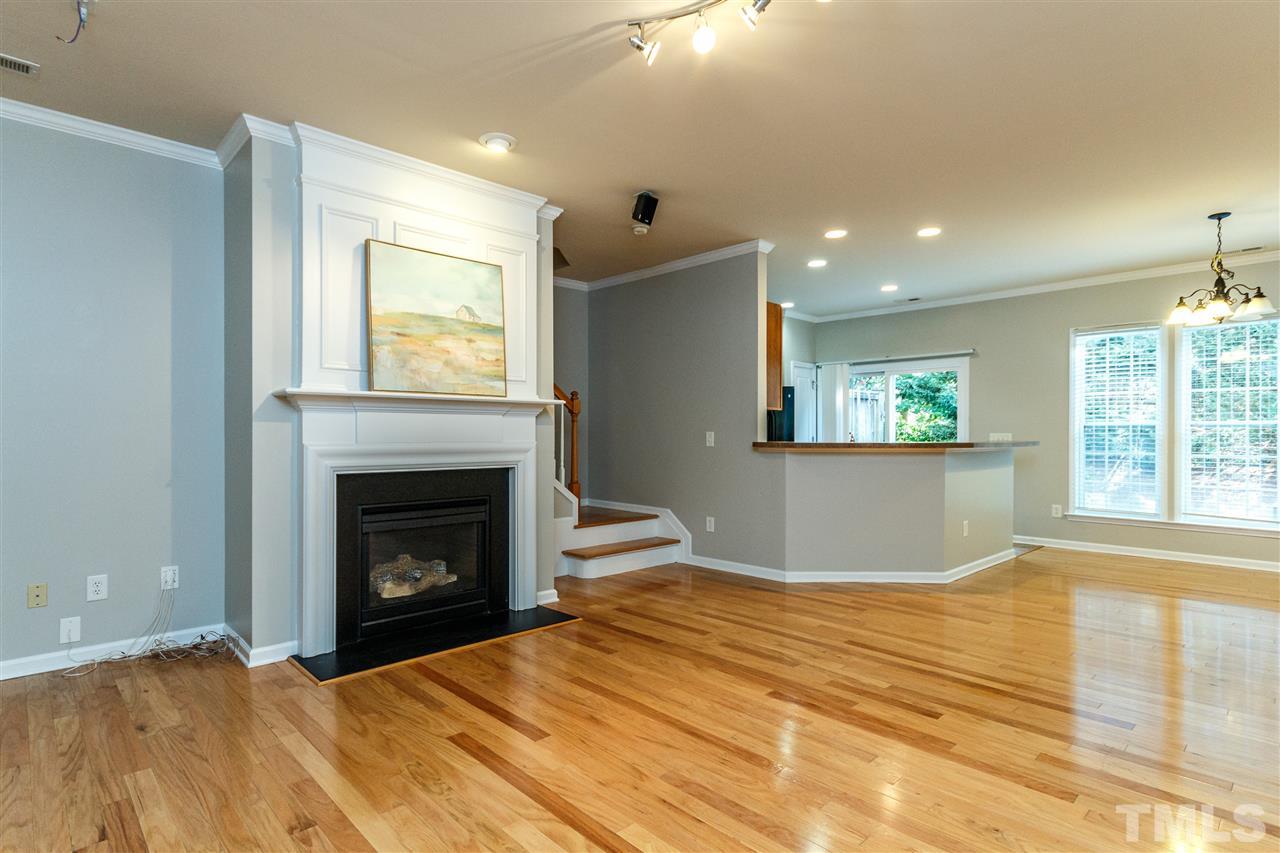 8306 Pilots View Drive Raleigh, NC 27617 - Photo 4 of 30 Freshly painted Family Room with Hardwood floors and gas log Fireplace. Great open living space.