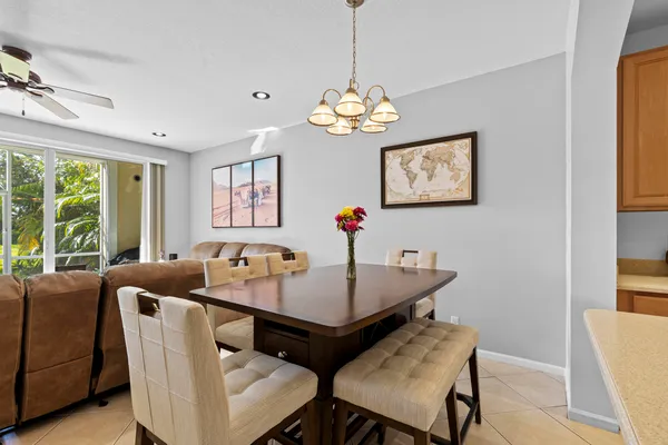 a living room with furniture a floor to ceiling window and a flat screen tv