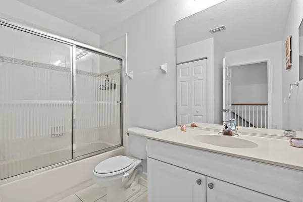 a living room with furniture potted plant and a table