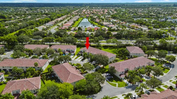 a view of a tennis ground with large trees