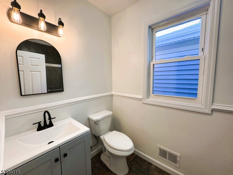 158 Catherine Street, Unit B Elizabeth, NJ 07201 - Photo 10 of 14 a bathroom with a toilet sink and mirror