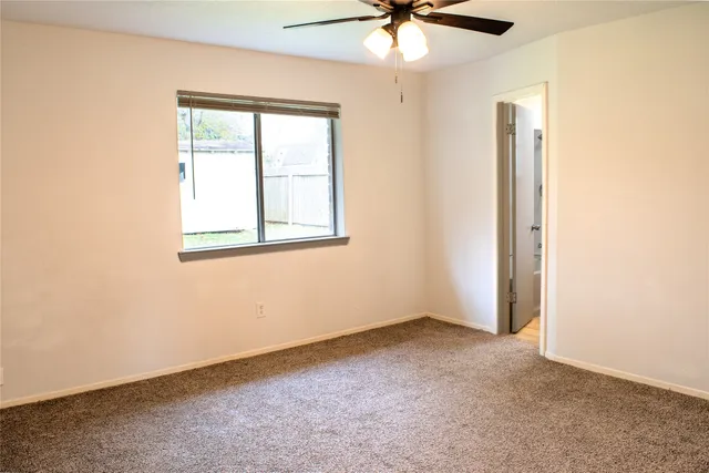 a bathroom with a granite countertop bathtub shower sink vanity and toilet
