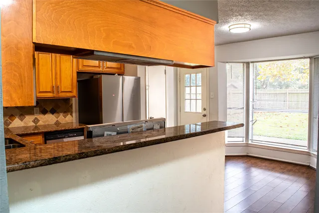 a view of a large kitchen with a large window
