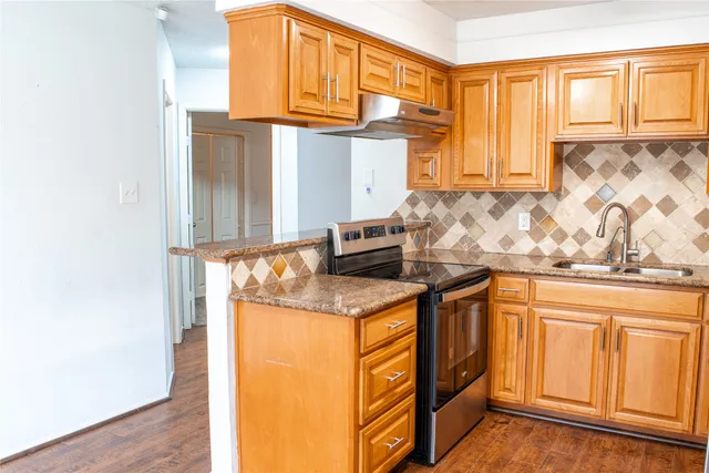 a kitchen with stainless steel appliances granite countertop a sink and a cabinets