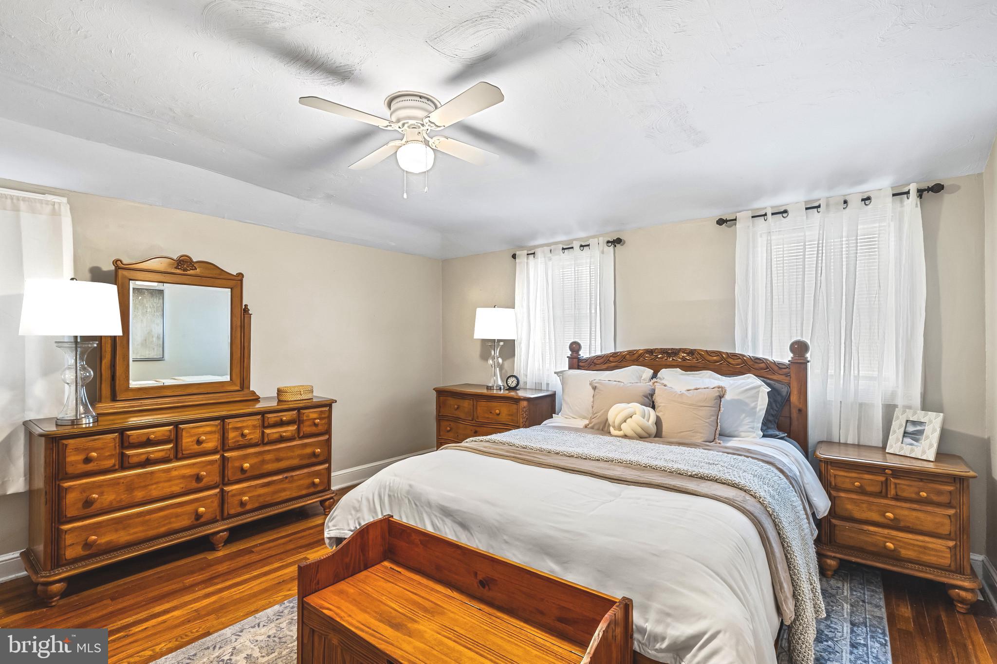 8362 Oakleigh Road Parkville, MD 21234 - Photo 13 of 28 a bedroom with a bed and wooden floor