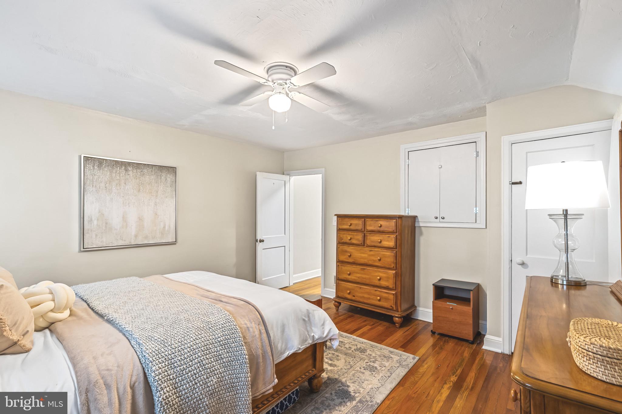 8362 Oakleigh Road Parkville, MD 21234 - Photo 14 of 28 a bedroom with a bed and a dresser
