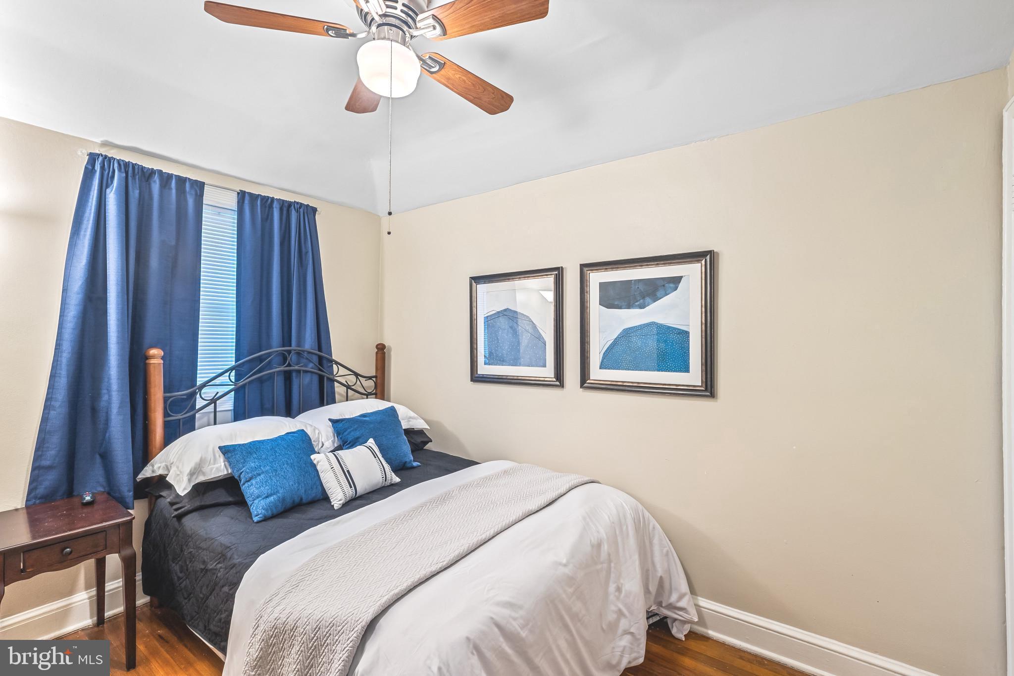 8362 Oakleigh Road Parkville, MD 21234 - Photo 16 of 28 a bedroom with a bed and a painting on the wall