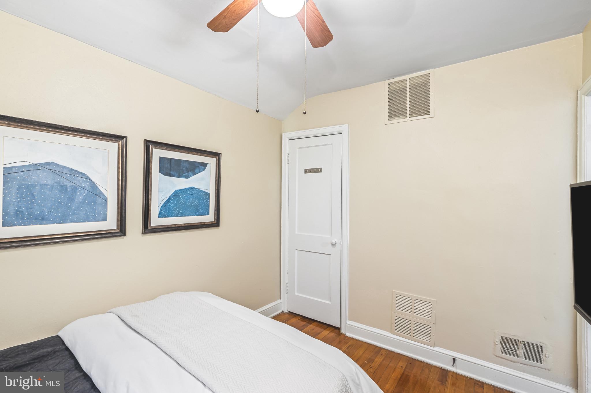 8362 Oakleigh Road Parkville, MD 21234 - Photo 17 of 28 a bedroom with a bed and a painting on the wall