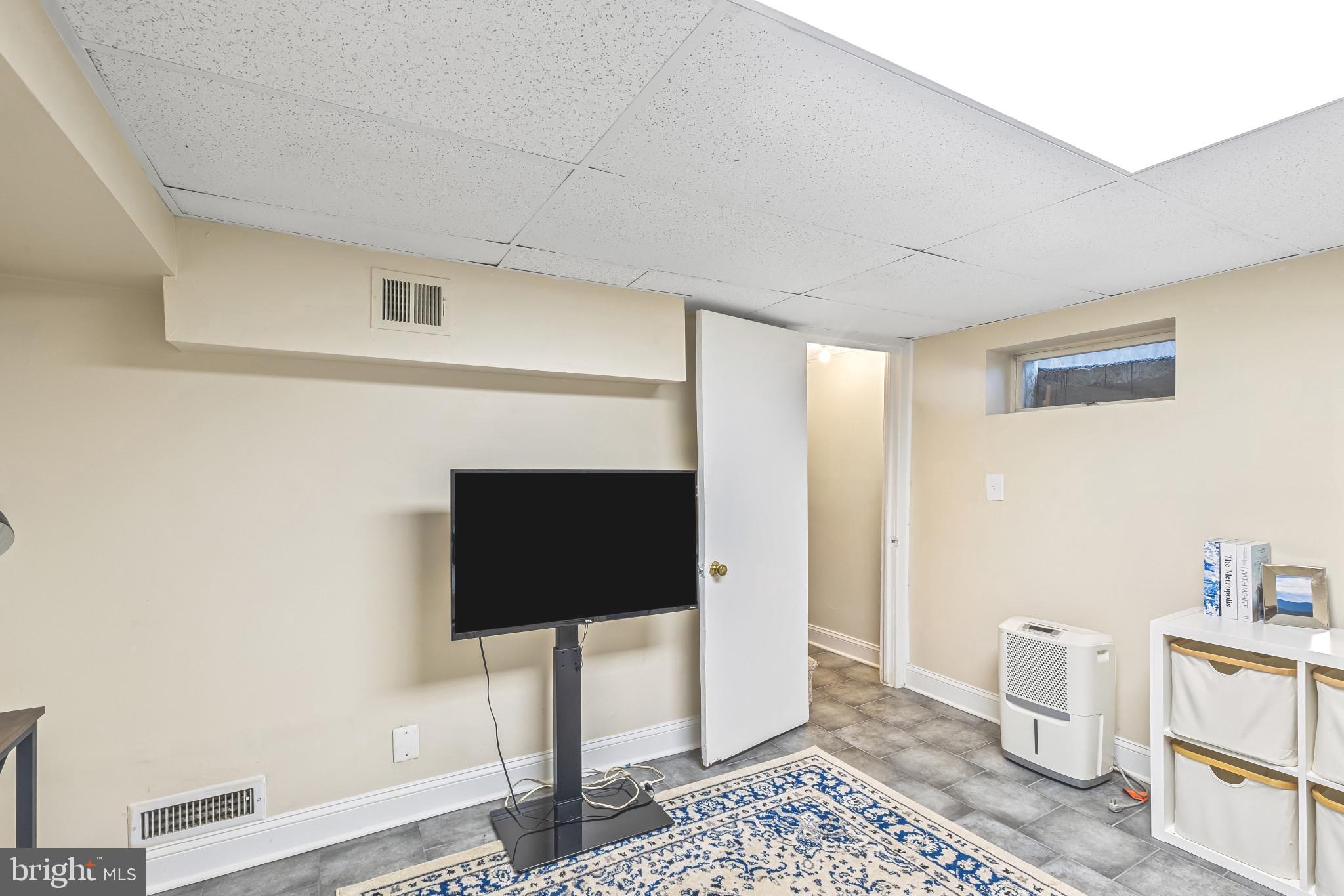 8362 Oakleigh Road Parkville, MD 21234 - Photo 21 of 28 a living room with furniture and a fireplace