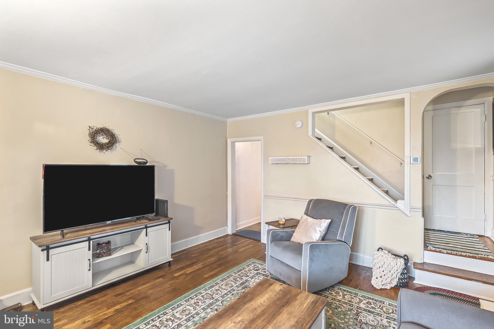 8362 Oakleigh Road Parkville, MD 21234 - Photo 5 of 28 a living room with furniture and a flat screen tv