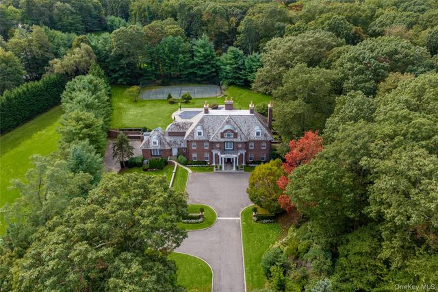 an aerial view of a house with swimming pool and garden
