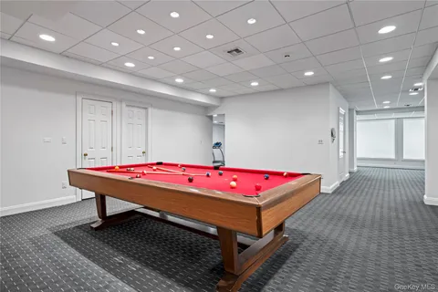 an aerial view of a house with a yard and outdoor seating