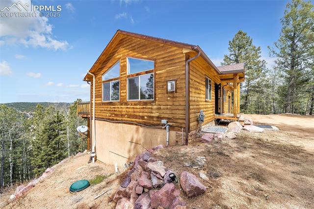 1055 Timber Ridge Road Divide, CO 80814 - Photo 34 of 47 View of property exterior featuring a view of trees