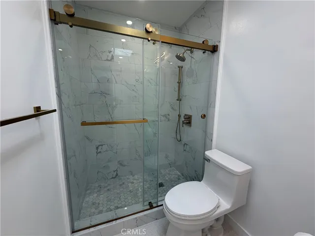 a white toilet sitting next to a bathroom