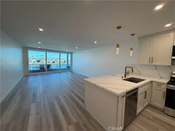 a kitchen with a sink and wooden floor