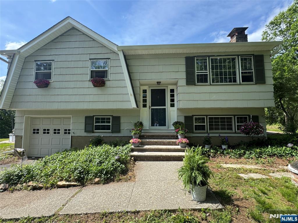 55 Maryann Road Oak Ridge, NJ 07438 - Photo 1 of 20 a front view of a house with a yard