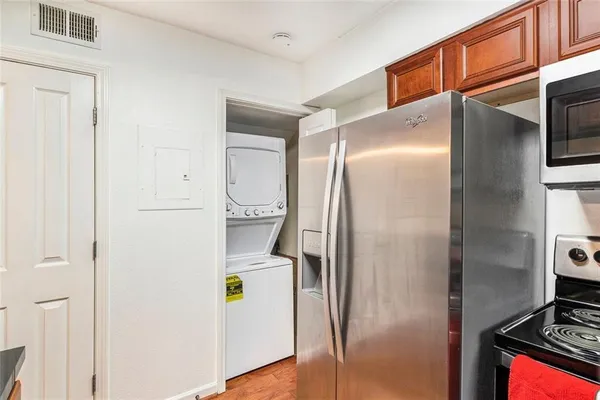 a kitchen with a refrigerator and a stove