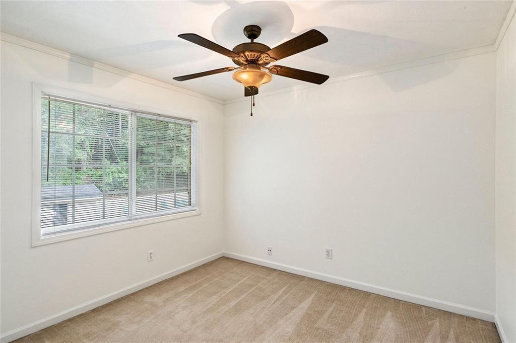 6940 Roswell Road, Unit 16B Atlanta, GA 30328 - Photo 15 of 27 an empty room with window and ceiling fan