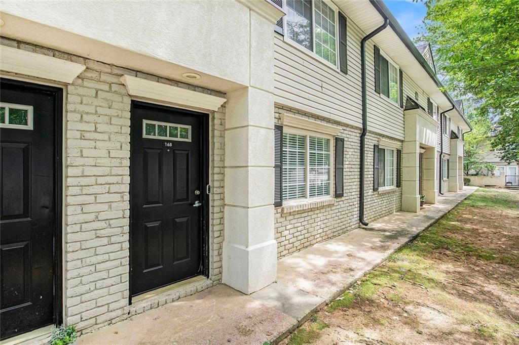 6940 Roswell Road, Unit 16B Atlanta, GA 30328 - Photo 2 of 27 a view of a brick house with a large windows