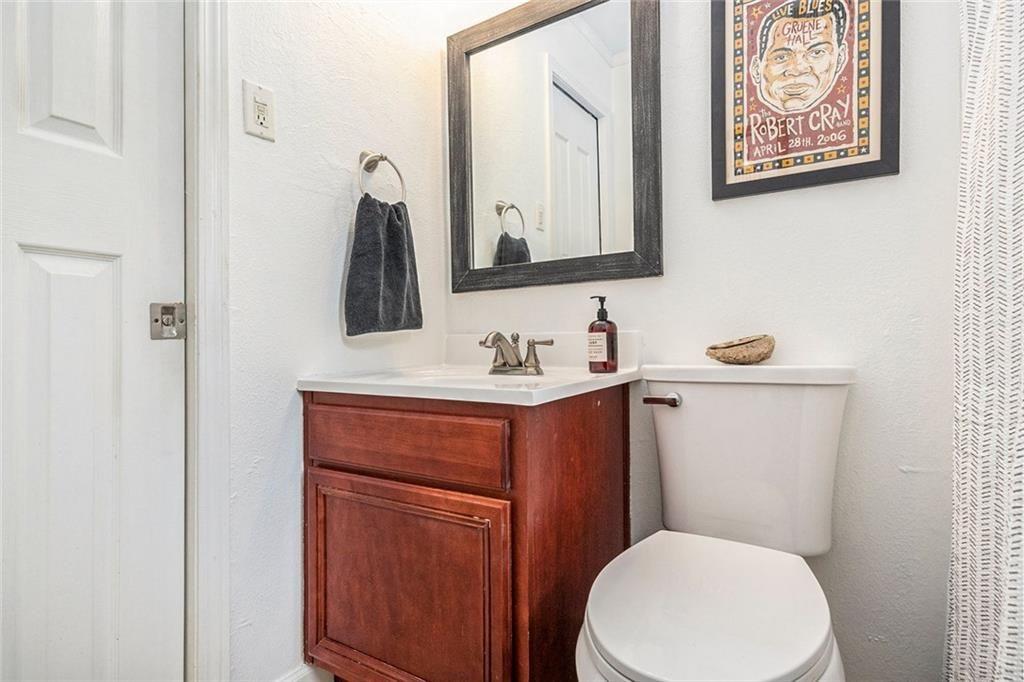 6940 Roswell Road, Unit 16B Atlanta, GA 30328 - Photo 23 of 27 a bathroom with a toilet sink and mirror