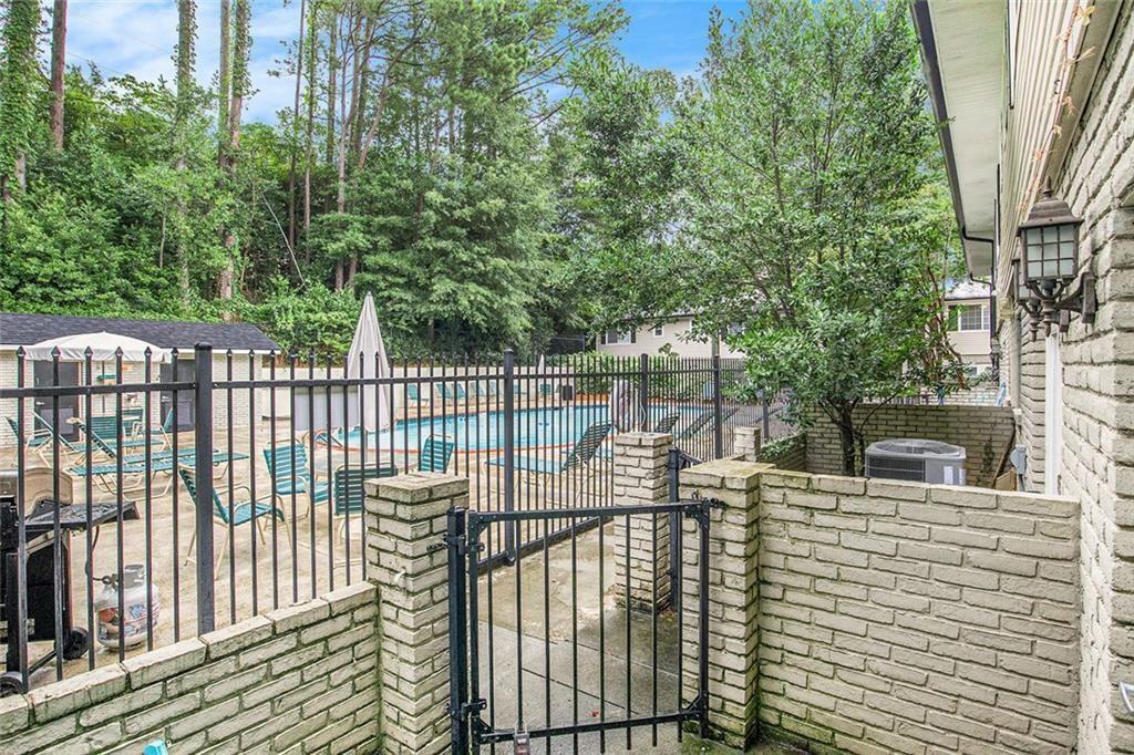 6940 Roswell Road, Unit 16B Atlanta, GA 30328 - Photo 25 of 27 a view of a balcony with floor to ceiling window and wooden fence
