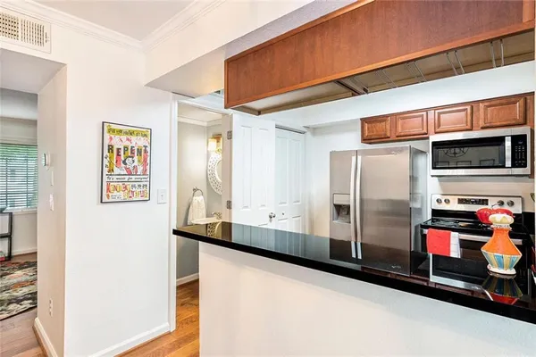 a kitchen with stainless steel appliances granite countertop a refrigerator and a stove