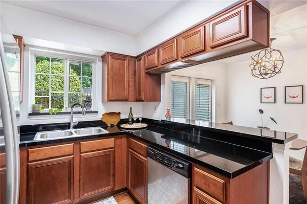 a kitchen with stainless steel appliances granite countertop a sink and a cabinets
