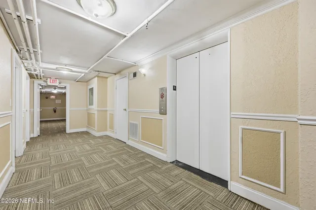 a view of empty room with white walls