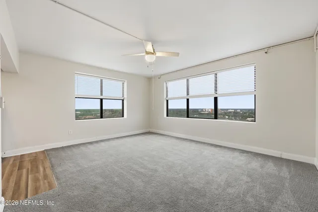 a view of an empty room with a kitchen