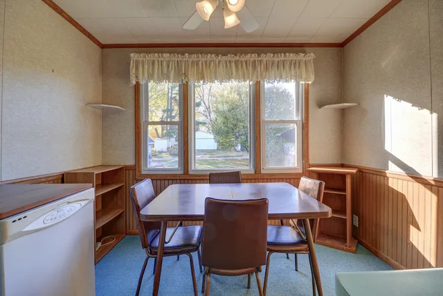 a view of a dining room with furniture window and wooden floor