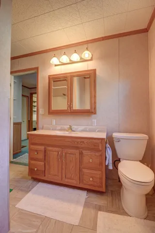 a bathroom with a toilet sink and mirror