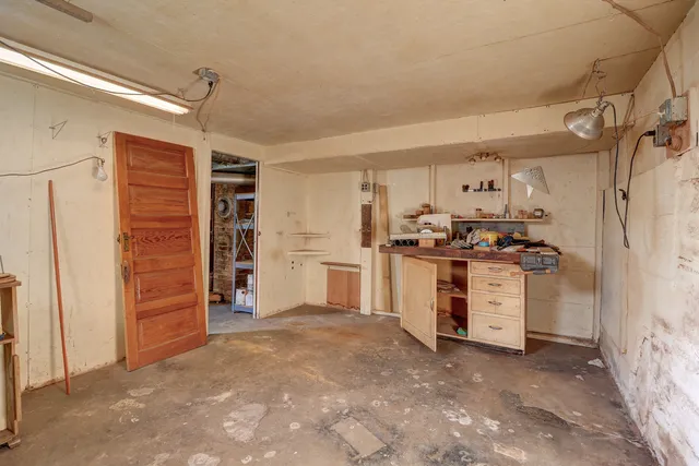 a view of a kitchen with refrigerator and cabinets