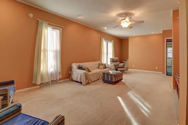 a living room with furniture and a chandelier