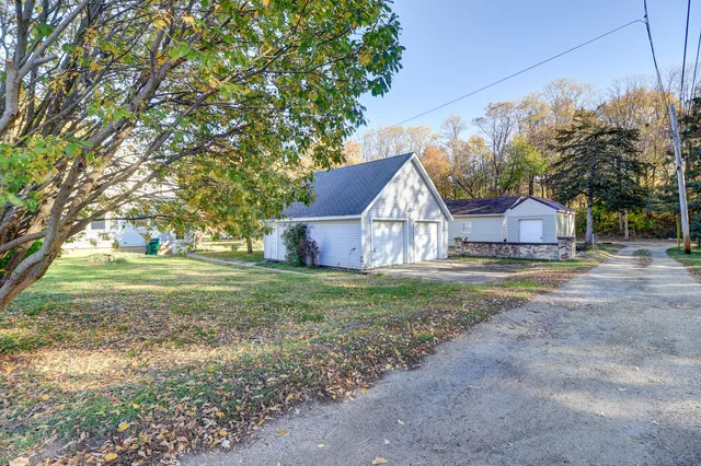 a view of house with backyard and tree