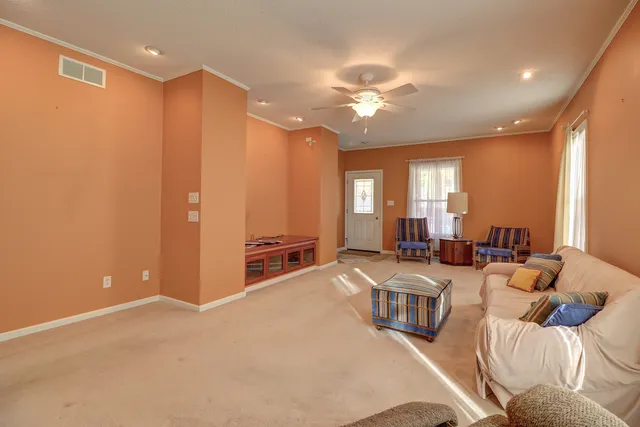 a large bedroom with furniture and a chandelier