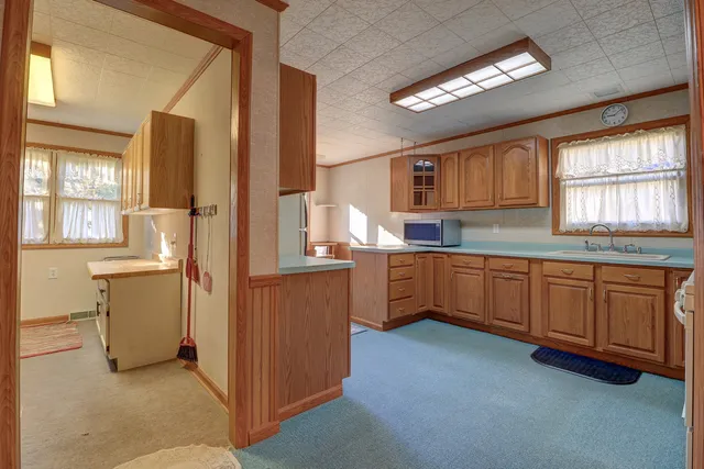 a kitchen with sink cabinets and window