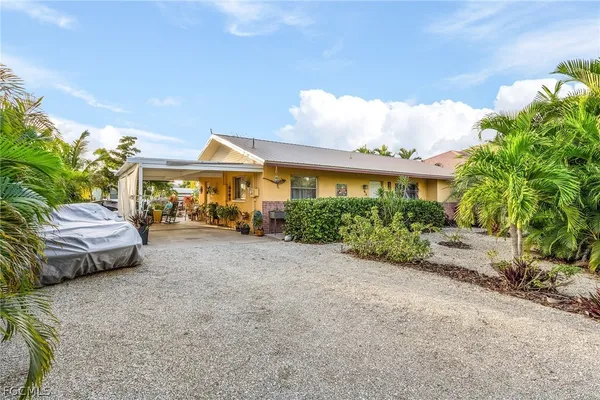 a view of patio with couches and table and chairs under an umbrella