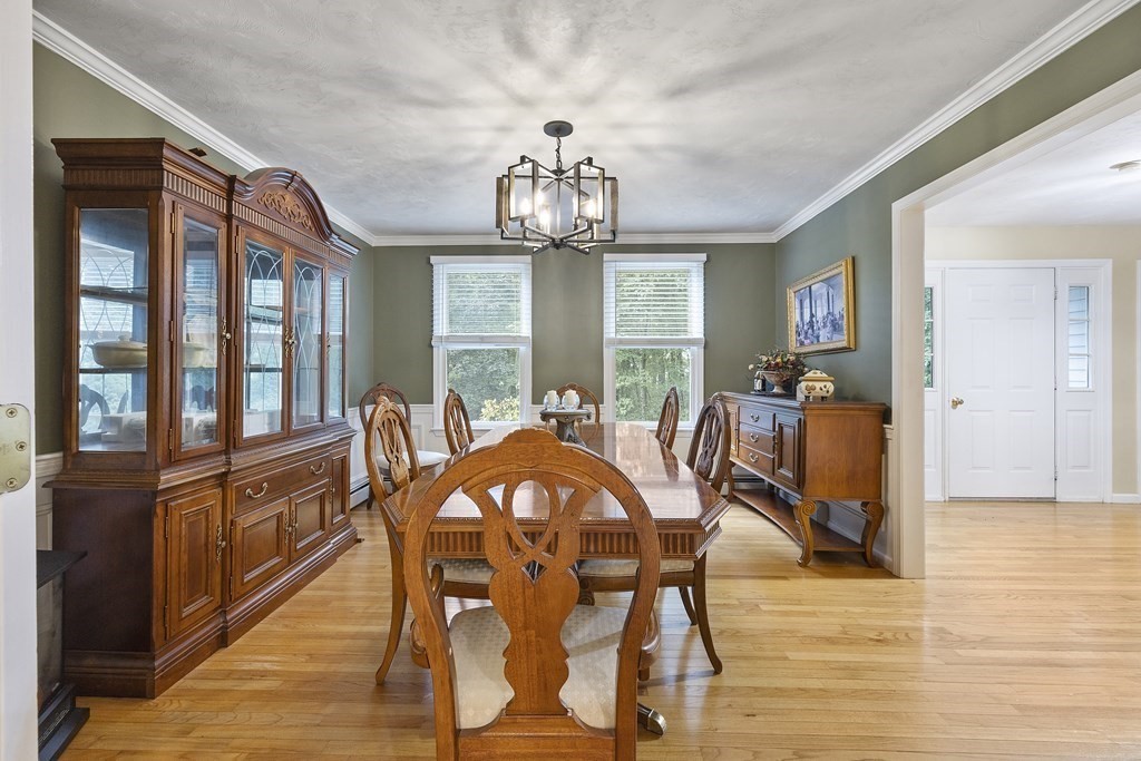 3 Daniels Road Medway, MA 02053 - Photo 11 of 28 a view of a dining room with furniture a chandelier and wooden floor