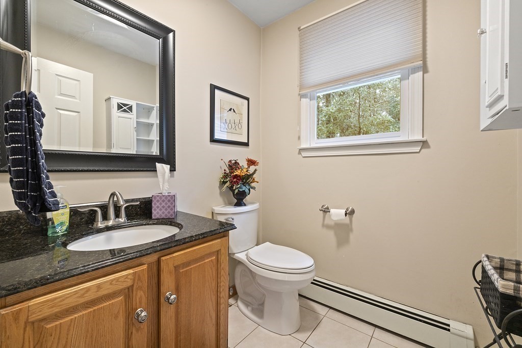 3 Daniels Road Medway, MA 02053 - Photo 15 of 28 a bathroom with a granite countertop toilet sink and mirror