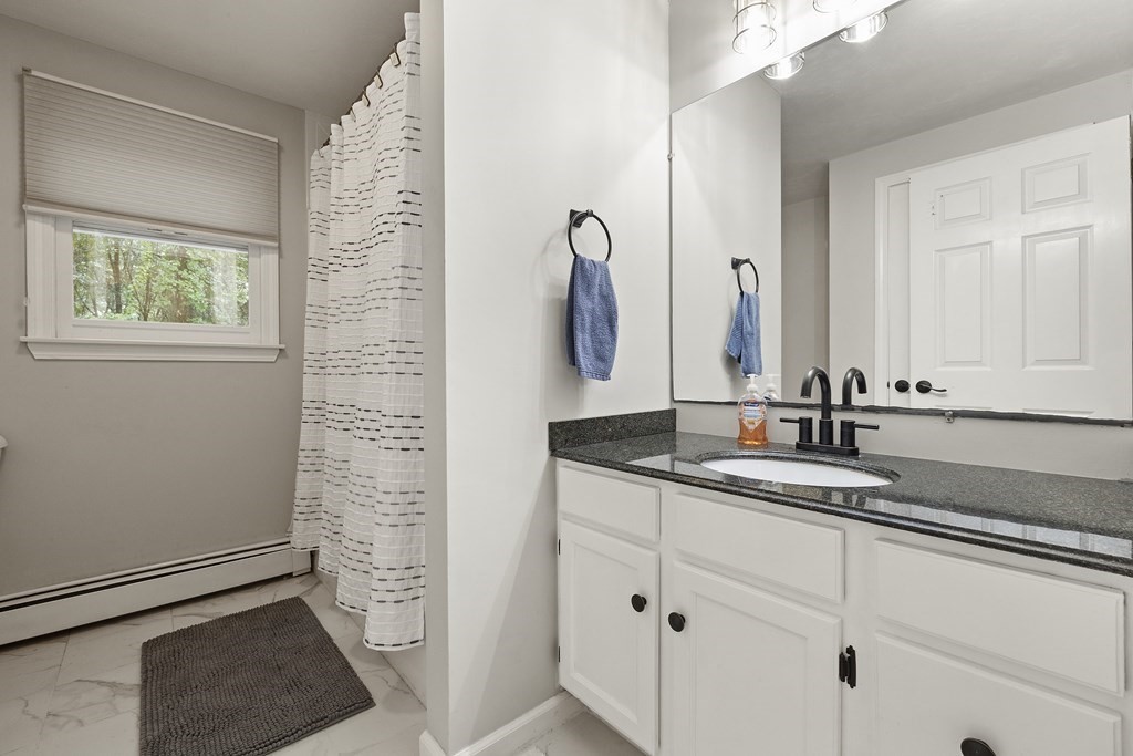 3 Daniels Road Medway, MA 02053 - Photo 20 of 28 a bathroom with a granite countertop sink and a mirror