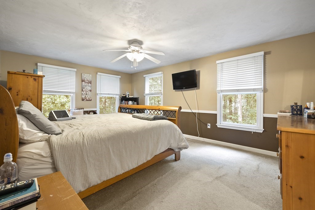 3 Daniels Road Medway, MA 02053 - Photo 21 of 28 a spacious bedroom with a bed and a chandelier