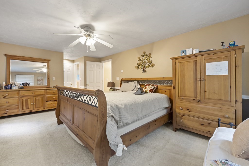 3 Daniels Road Medway, MA 02053 - Photo 22 of 28 a spacious bedroom with a bed and a chandelier