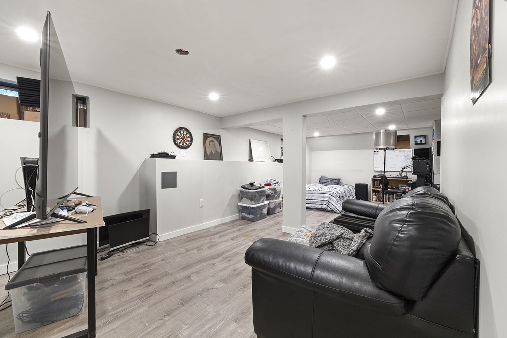 3 Daniels Road Medway, MA 02053 - Photo 25 of 28 a living room with furniture gym equipment and a wooden floor