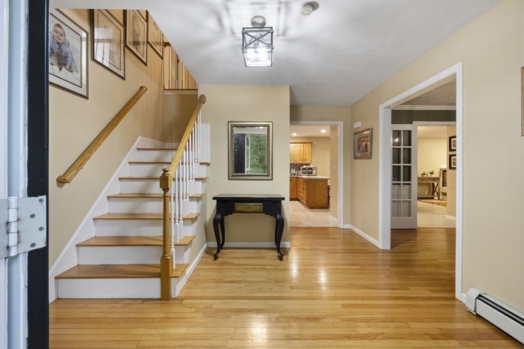 3 Daniels Road Medway, MA 02053 - Photo 9 of 28 a view of an entryway with wooden floor and a chandelier