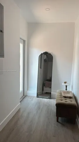 a living room with a bed and a mirror