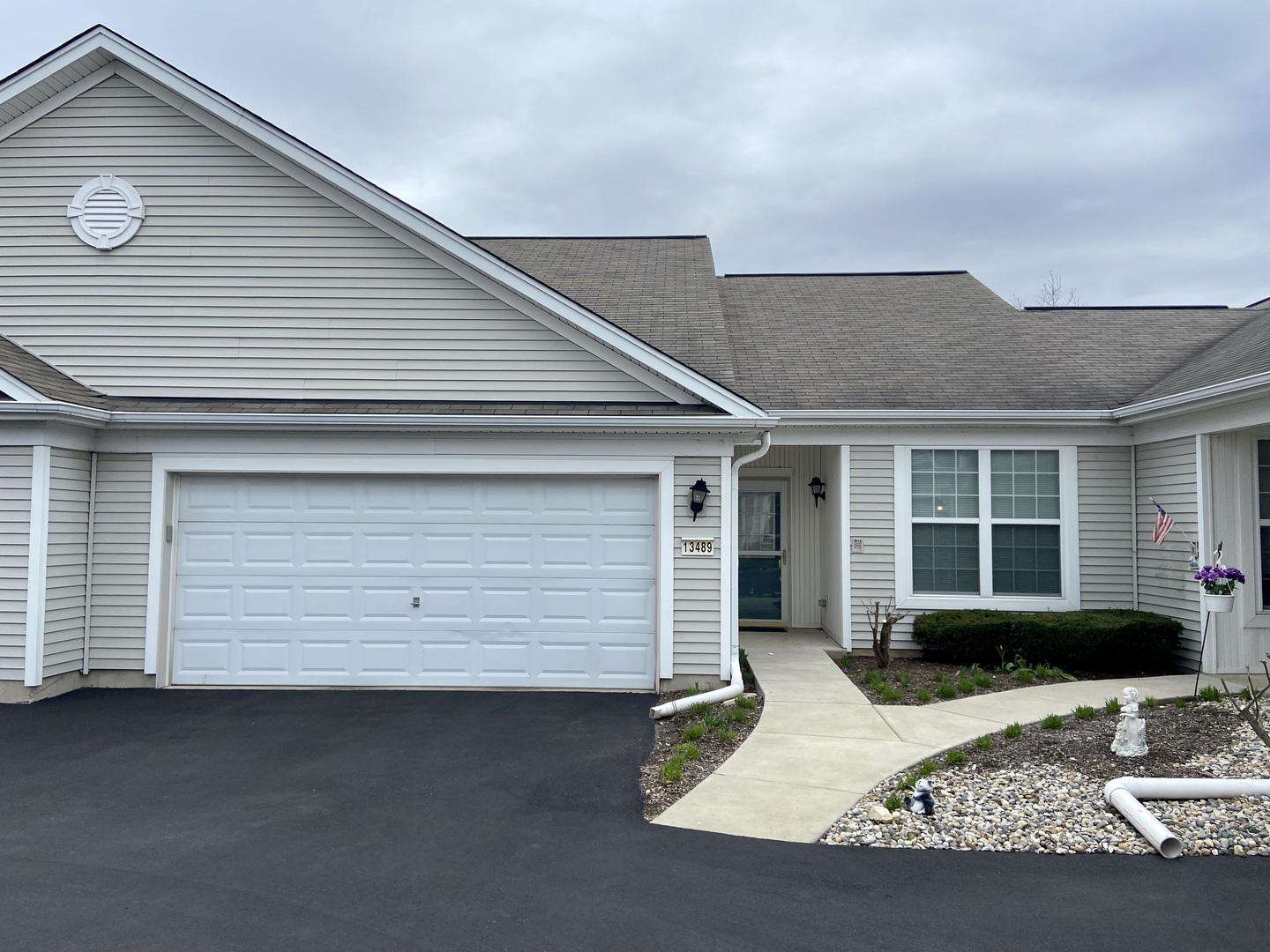 13489 Delaney Road Huntley, IL 60142 - Photo 1 of 17 a front view of a house with a garden