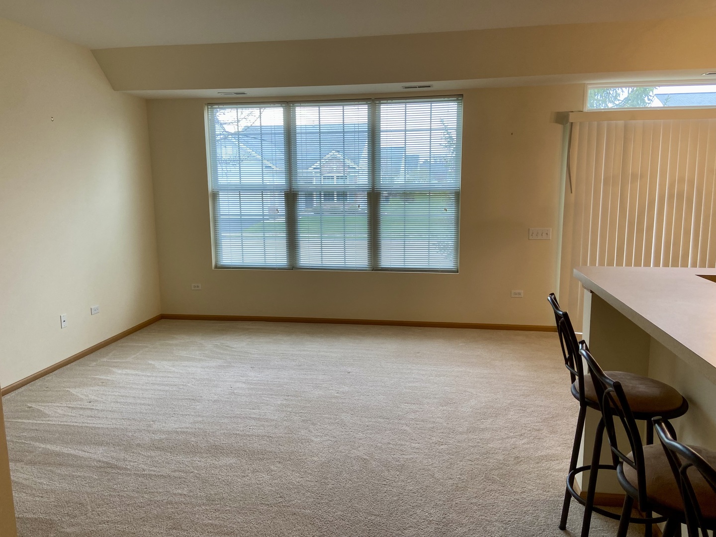 13489 Delaney Road Huntley, IL 60142 - Photo 7 of 17 a view of an empty room with a window and chair