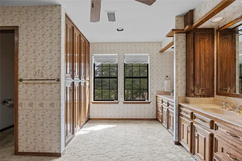 a large kitchen with a large window and stainless steel appliances