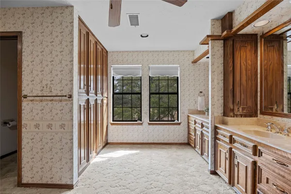 a large kitchen with a large window and stainless steel appliances